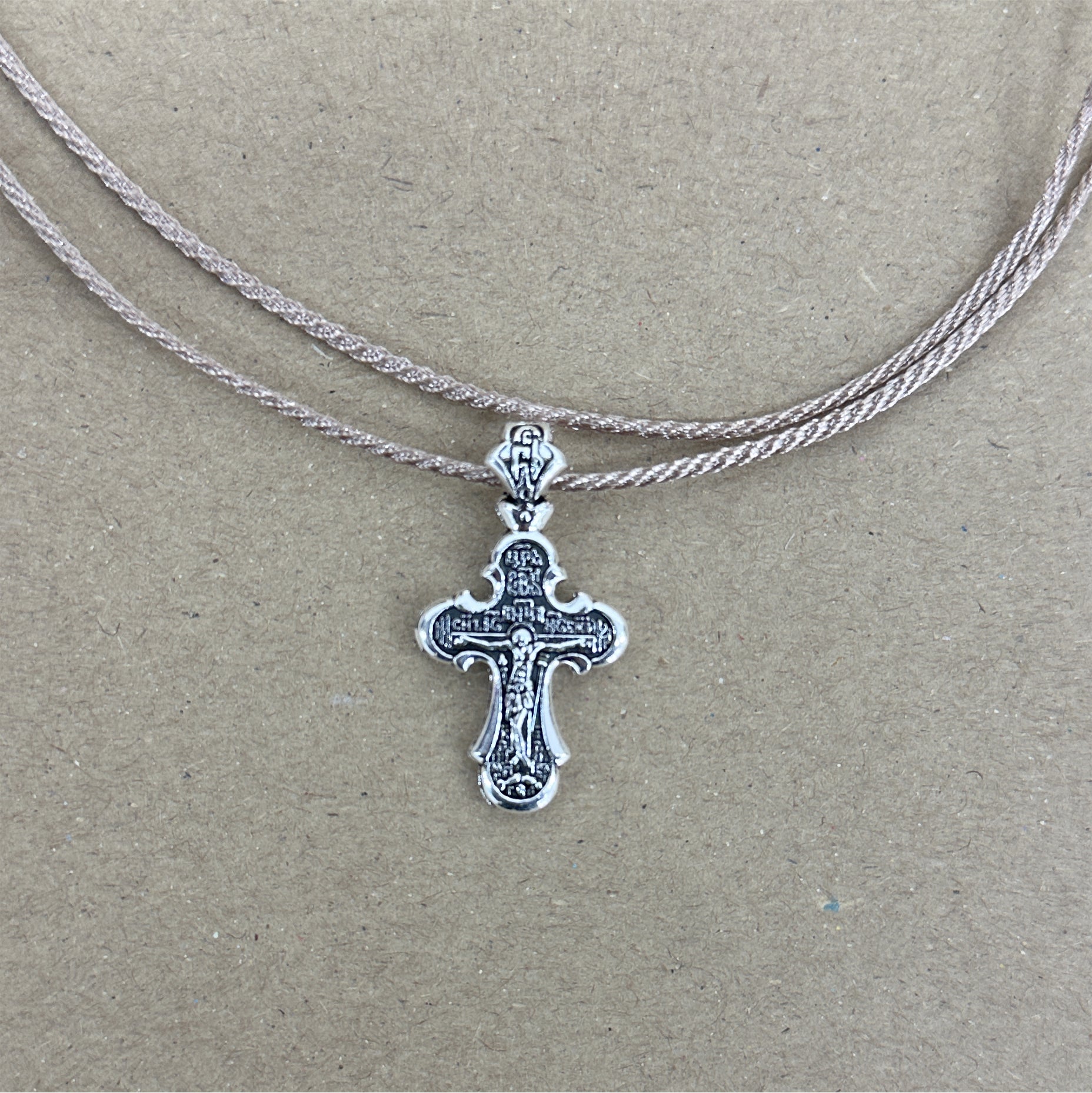 METAL CROSS PENDANT WITH BROWN CORD IN WHITE POUCH - 10 pcs